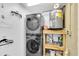 Functional laundry area with stacked washer/dryer and shelving for storage and essentials at 14124 Kulig Ct, Hudson, FL 34667