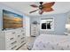 Bedroom featuring light blue walls, TV, ceiling fan, and lots of natural light at 14124 Kulig Ct, Hudson, FL 34667