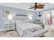 Charming bedroom with light blue walls, flamingo themed bedding, and decorative ceiling fan at 14124 Kulig Ct, Hudson, FL 34667