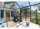 Enclosed patio with outdoor dining, grill, and views of the canal at 14124 Kulig Ct, Hudson, FL 34667