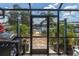 Enclosed patio with outdoor dining, grill, and views of the canal at 14124 Kulig Ct, Hudson, FL 34667