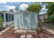 Exterior view of a storage shed with secure doors and maintained landscaping at 14124 Kulig Ct, Hudson, FL 34667