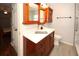Updated bathroom features a wood vanity, a white countertop, and modern fixtures, complemented by neutral tile at 4649 Westerly Dr, New Port Richey, FL 34653