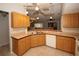 Well-lit kitchen featuring light wood cabinets, white appliances, and a convenient double sink at 4649 Westerly Dr, New Port Richey, FL 34653
