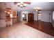 Inviting living space featuring wood flooring transitioning to tiled bar with seating and cabinet lighting at 4649 Westerly Dr, New Port Richey, FL 34653
