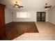 Spacious living room featuring dual ceiling fans, wood flooring, and access to a tiled area at 4649 Westerly Dr, New Port Richey, FL 34653