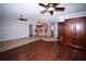 Open-concept living space with wood floors flowing into a tiled kitchen bar area with three barstools at 4649 Westerly Dr, New Port Richey, FL 34653