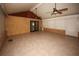 Enclosed sunroom with tile floor, textured walls, beamed ceiling, and ceiling fans at 4649 Westerly Dr, New Port Richey, FL 34653