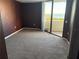 Cozy carpeted bedroom features sliding glass doors opening to a balcony with lovely ocean views at 5915 Sea Ranch Dr # 501, Hudson, FL 34667