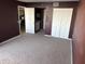 Carpeted bedroom with closet, adjacent bar, and dining area at 5915 Sea Ranch Dr # 501, Hudson, FL 34667