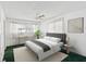 Bright bedroom with a plush bed, white linens, and natural light streaming through the windows at 7037 Versailles N # 15, Pinellas Park, FL 33781