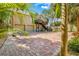 Charming two-story home with a brick driveway, two-car garage, and tropical landscaping at 8711 Betty St, Port Richey, FL 34668