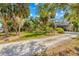 Beautiful landscaping frames this home with its balcony and brick driveway at 8711 Betty St, Port Richey, FL 34668
