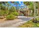 Landscaped yard featuring gravel groundcover and mature palm trees in a serene setting at 8711 Betty St, Port Richey, FL 34668