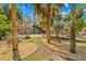 Scenic yard with shady trees, stone mulch beds and lush green lawn at 8711 Betty St, Port Richey, FL 34668