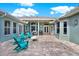 Open-air backyard patio featuring bright furniture, a cooking area, and lovely hardscape pavers at 10030 Orchard Way, Spring Hill, FL 34608