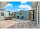 Inviting backyard patio featuring a comfortable dining area and beautiful brick pavers at 10030 Orchard Way, Spring Hill, FL 34608