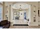 Elegant foyer featuring tile flooring, decorative columns, and a tray ceiling at 10030 Orchard Way, Spring Hill, FL 34608