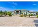 Stunning light blue home features a paver driveway and a beautifully landscaped front yard at 10030 Orchard Way, Spring Hill, FL 34608