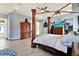 Spacious main bedroom featuring wood look floors and a unique canopy bed at 10030 Orchard Way, Spring Hill, FL 34608