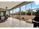 Inviting screened patio featuring tile flooring, ceiling fans, and lovely backyard views at 10030 Orchard Way, Spring Hill, FL 34608