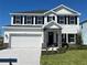 Charming two-story home showcasing a well-maintained lawn and a two car garage at 10118 Zennia Ln, Parrish, FL 34219