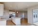 Modern kitchen with stainless steel appliances, island, and a seamless connection to the living area at 10118 Zennia Ln, Parrish, FL 34219