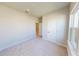 Cozy bedroom with neutral walls, plush carpet, natural light, and bright white doors at 10123 Zennia Ln, Parrish, FL 34219