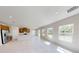Bright, open-concept living room with natural light and sliding glass doors to outdoor at 10123 Zennia Ln, Parrish, FL 34219
