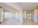 Bright hallway with neutral paint, tile flooring, and access to multiple rooms within the home at 10127 Zennia Ln, Parrish, FL 34219