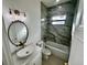 Elegant bathroom featuring marble-tiled walls, vintage mirror, and a stylish vessel sink at 12102 Chapman Ave, Port Charlotte, FL 33953