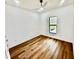 Bright and airy bedroom with wood floors and a large window at 12102 Chapman Ave, Port Charlotte, FL 33953