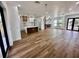 Open-concept living space with wood floors and modern light fixtures at 12102 Chapman Ave, Port Charlotte, FL 33953