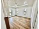 Bright, spacious main bedroom with tray ceiling and wood-look flooring at 12102 Chapman Ave, Port Charlotte, FL 33953