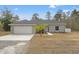 Charming single-story home features a well-maintained lawn, attached two-car garage and freshly painted exterior at 13094 Tailorbird Ave, Brooksville, FL 34614