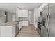 Bright and modern kitchen features stainless steel appliances, granite countertops, and ample cabinet space at 13094 Tailorbird Ave, Brooksville, FL 34614