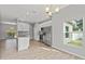 Bright, open-concept kitchen with white cabinets, granite countertops, and stainless steel appliances at 13094 Tailorbird Ave, Brooksville, FL 34614