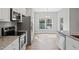 Modern kitchen and dining area featuring stainless steel appliances, granite countertops, and an open concept layout at 13094 Tailorbird Ave, Brooksville, FL 34614