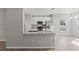 Modern kitchen featuring white cabinets, granite countertops, stainless steel appliances, and an open concept layout at 13094 Tailorbird Ave, Brooksville, FL 34614