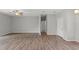 Spacious living room featuring wood-look flooring and neutral walls leading to bedrooms and living spaces at 13094 Tailorbird Ave, Brooksville, FL 34614
