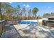Pool deck showcasing the above ground pool, with a safety cover and a surrounding privacy screen at 13094 Tailorbird Ave, Brooksville, FL 34614