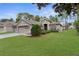 Well-maintained front yard with lush green grass, mature trees, and appealing curb, enhancing the home's exterior at 4178 Braemere Dr, Spring Hill, FL 34609