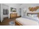 Comfortable bedroom with a wooden dresser, TV, and a bed with blue accents at 5173 Pacific Ave, Spring Hill, FL 34607