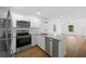 Modern kitchen featuring stainless appliances, sleek white cabinets, and granite counters at 5173 Pacific Ave, Spring Hill, FL 34607