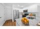 Modern kitchen with stainless appliances, white cabinets, granite counters and hardwood floors at 5173 Pacific Ave, Spring Hill, FL 34607
