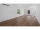 Spacious, bright living room with hardwood flooring and modern ceiling fan at 5173 Pacific Ave, Spring Hill, FL 34607