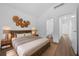 Relaxing main bedroom with hardwood floors, neutral paint, and an en-suite bathroom at 5173 Pacific Ave, Spring Hill, FL 34607