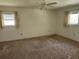 A bedroom with carpeted floors, neutral walls, and windows that provide ample natural light at 12501 Shadow Ridge Blvd, Hudson, FL 34669