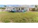 Large backyard with well-maintained lawn and patio area, great for entertaining or relaxing outdoors at 13705 Allyn Dr, Hudson, FL 34667