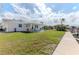Spacious backyard with lush green lawn, patio seating, and canal access, perfect for outdoor living at 13705 Allyn Dr, Hudson, FL 34667